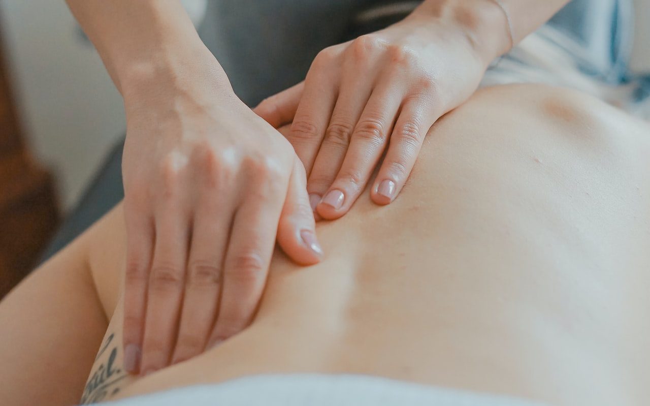 man massaging woman's body